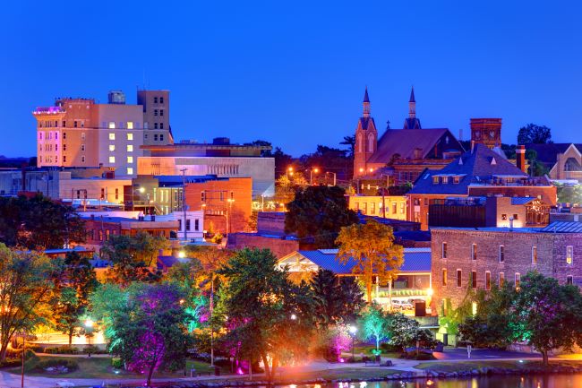 a sunset image of rockford photographed with colorful lights on the street