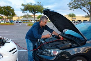 Man holds jump start cables