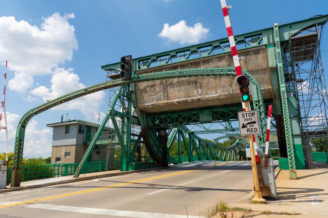 an image of cass st bridge in joliet illinois that sits on des plaines river