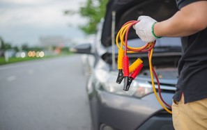 Man holds jump start cables