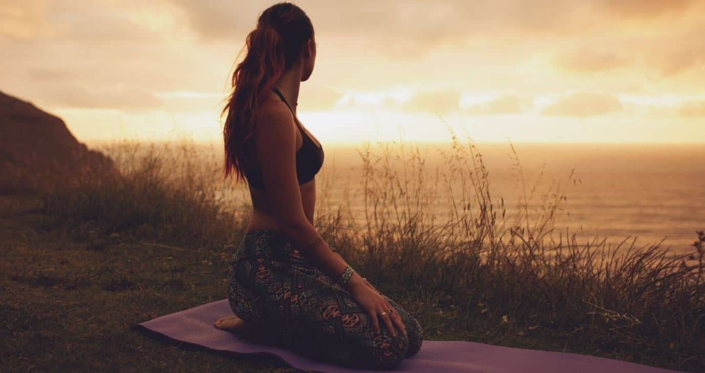 Woman exercises in dusk